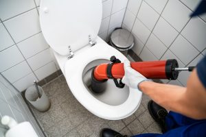 Plumber Toilet Blockage Assistance. WC Cleaning And Plumbing,Image: 712802607, License: Royalty-free, Restrictions: , Model Release: yes
